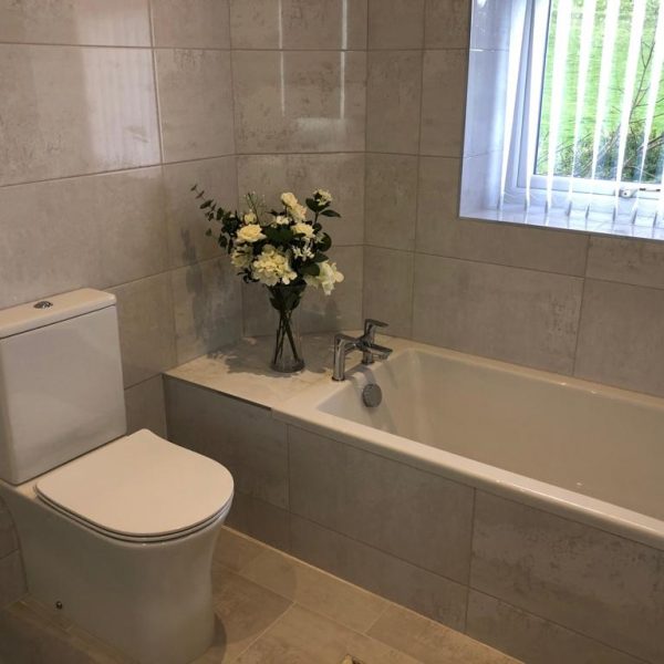 Grey tiled bathroom with toilet and bathroom by Bathroom Inspirations Dorchester