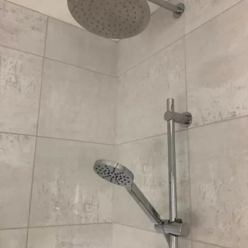 2 silver shower heads by Bathroom Inspirations Dorchester