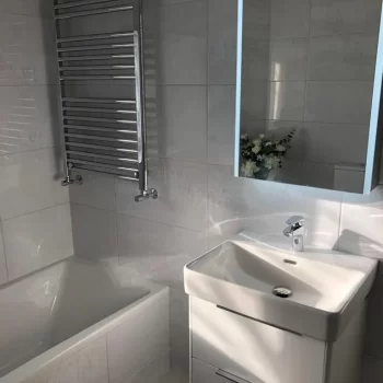 Bath, Radiator, Mirror and Sink in bathroom in Dorchester